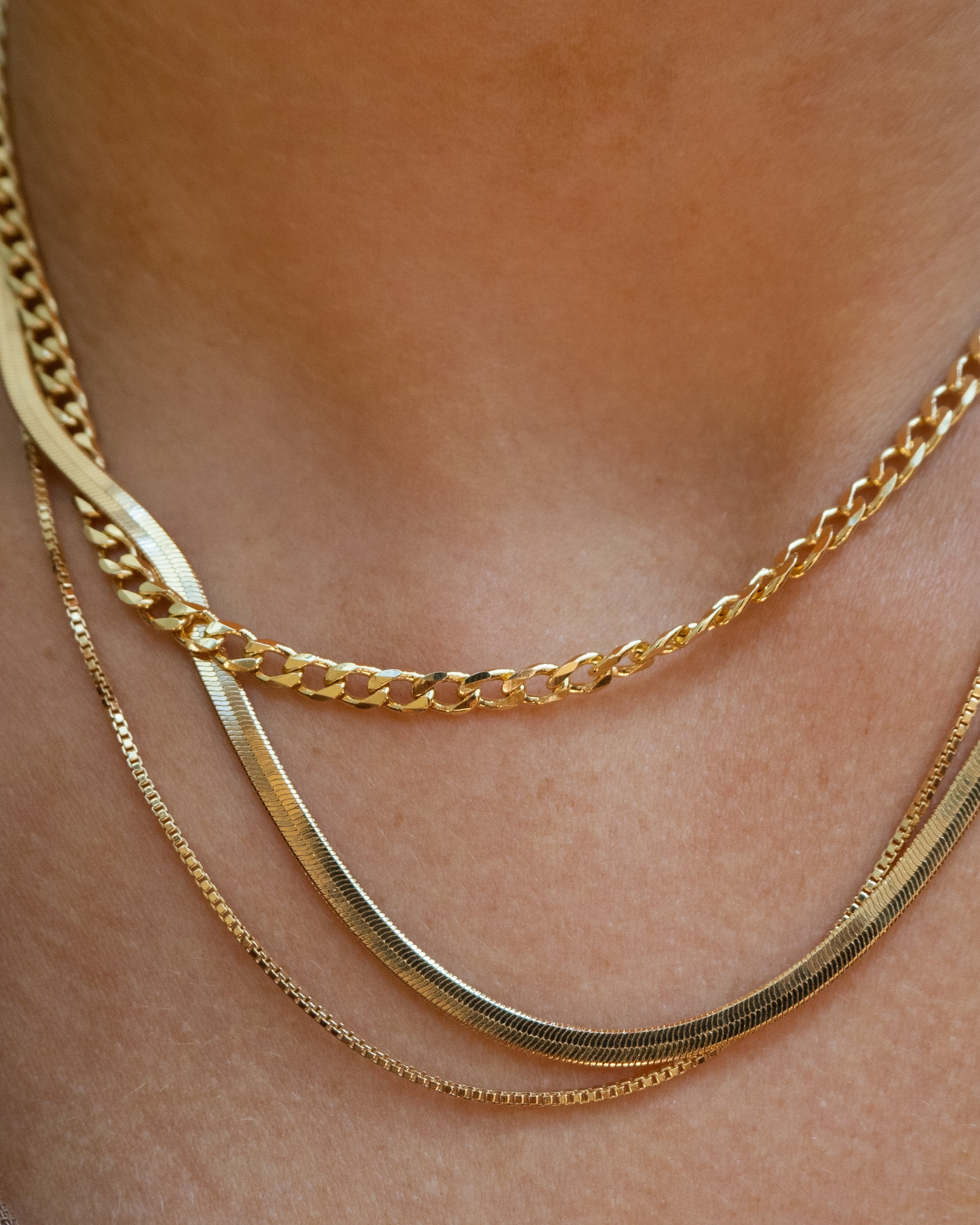 Dainty medium cuban link layering chain in 14k gold filled by Vie en Bleu jewelry.Dainty curb chain, dainty layering chain, 14k, 18k, gold filled chain, gold filled layering chain, mini curb chain, dainty cuban chain, mini curb link necklace, gold filled dainty jewelry, gold filled dainty, dainty necklace, gold layering necklace chain, water resistant, dainty jewelry, dainty necklace